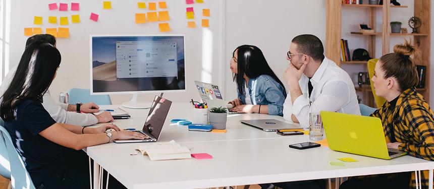 Diverse team of employees engaged in a professional meeting, fostering an inclusive environment for varied work styles
