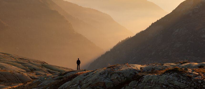 Man walking through mountains, symbolising navigating global security risks and changes in 2025.