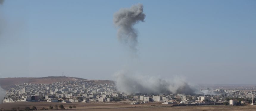Image showing aftermath of airstrikes in middle eastern city, referring to the Israel-Iran conflict