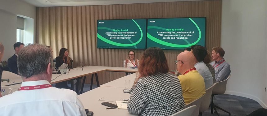 A roundtable event in London with travel and security risk professionals seated around a large table, engaged in discussion about travel risk management.