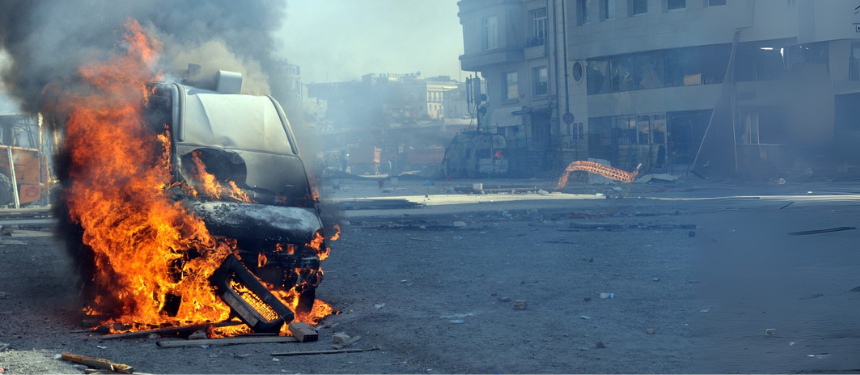 Burning car during unrest representing rioting on the street in Nepal